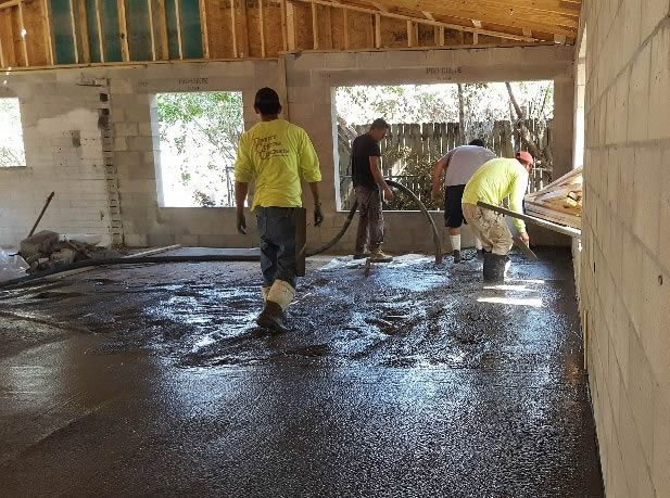 CFL Renovations' workers pouring cement on floor